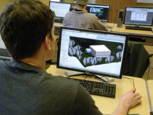 A construction management student makes a 3-D building model using specialized software