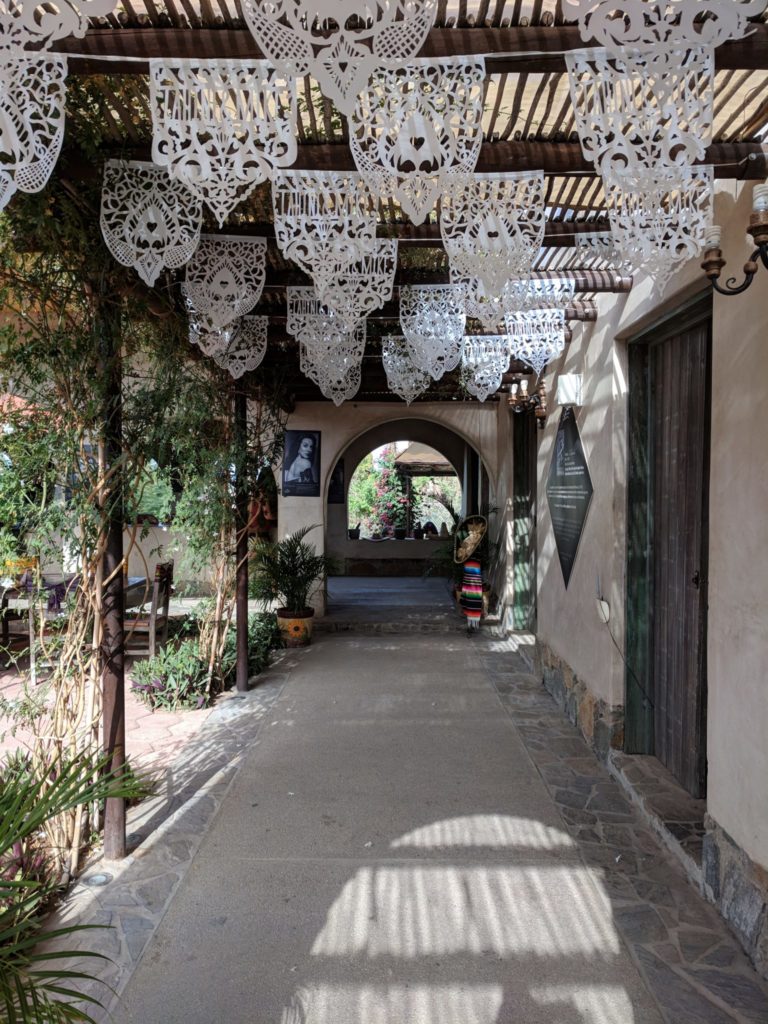 A patio decorated with delicate white flags.