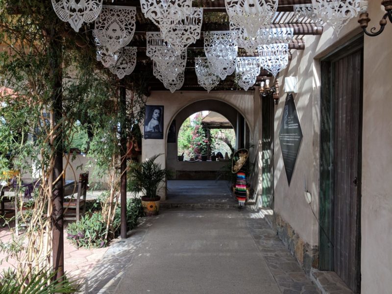 A patio decorated with delicate white flags.