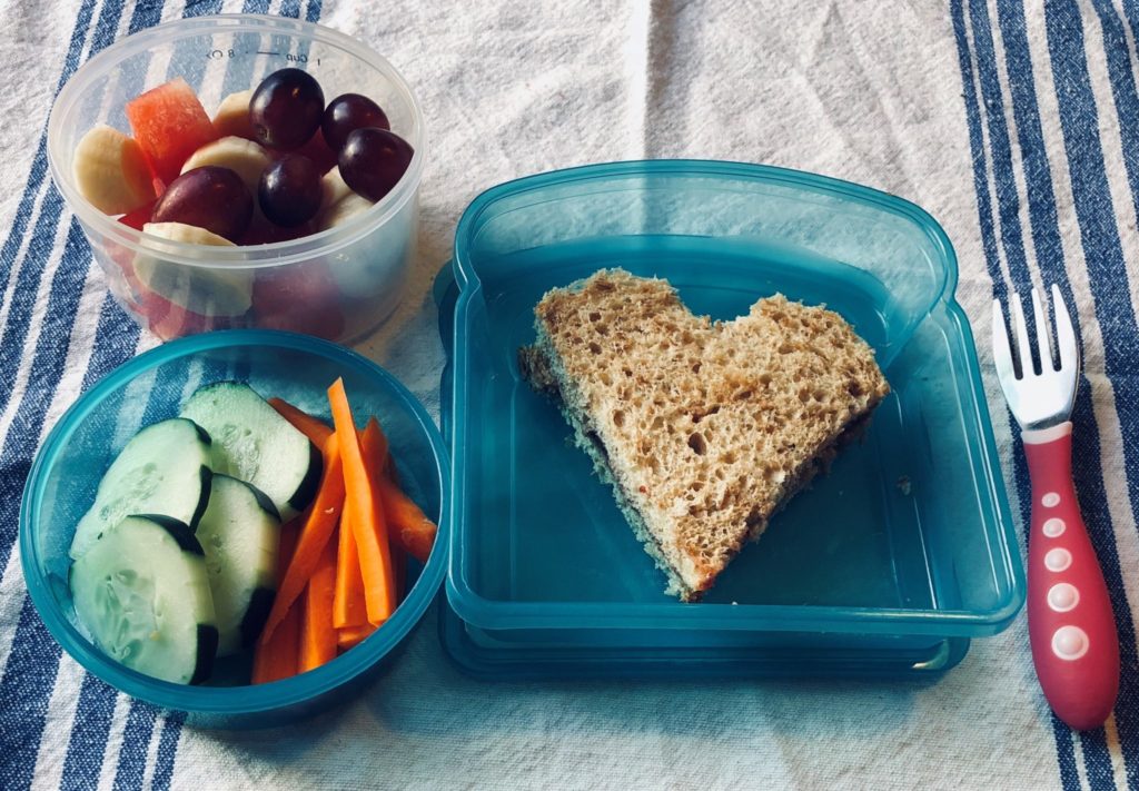 sandwich in heart shape with fruit and veggies