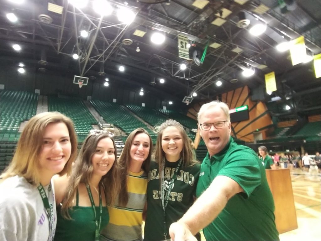 Dean Jeff McCubbin takes a selfie with four incoming freshman in Moby Arena.