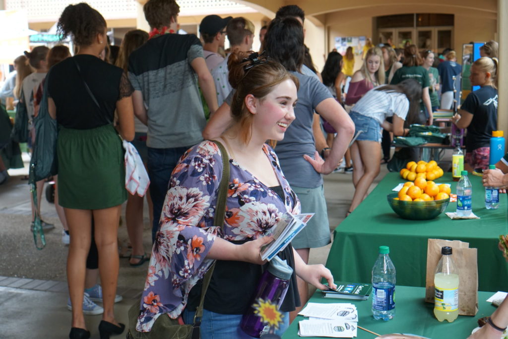 A students smiles as she approaches the CHHS Ram Welcome table.