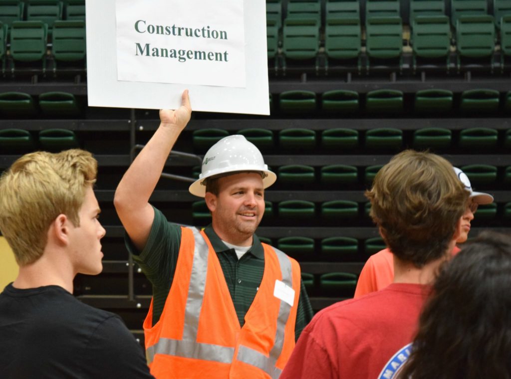 A construction management faculty member gathers incoming Freshman so that they can tour the campus and their departments.