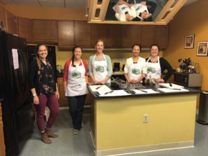 Five people with aprons in the KRNC