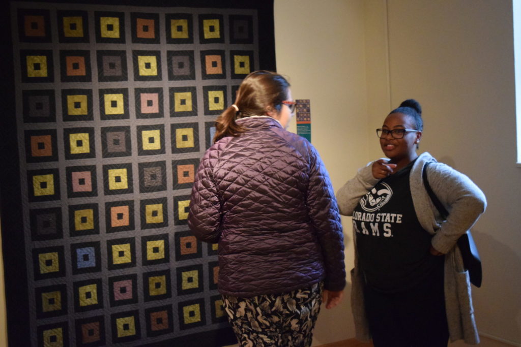 Vistors to the Gustafson Gallery admire the quilts.