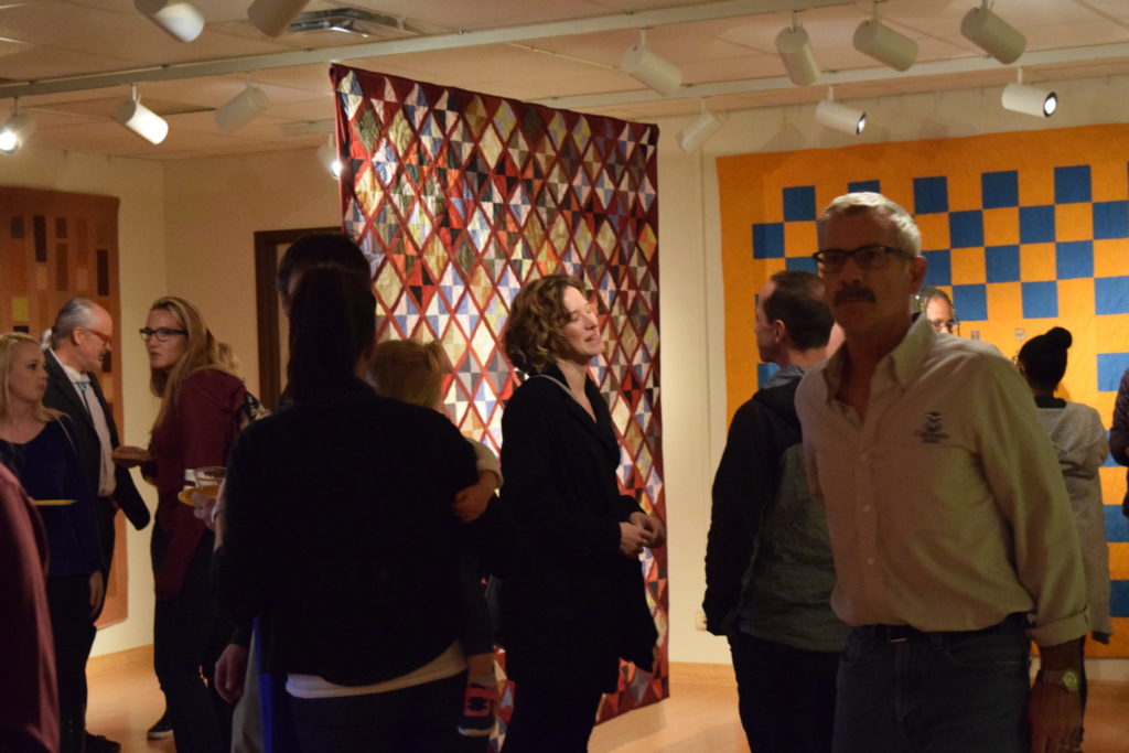 Vistors to the Gustafson Gallery admire the quilts.