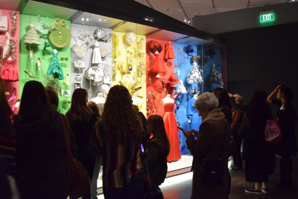 A rainbow display attracts the attention of numerous museum guests.