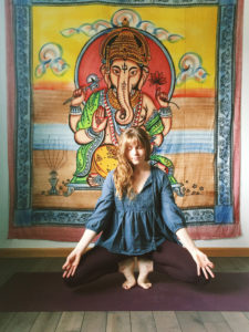 Megan Majors in a yoga pose in the studio