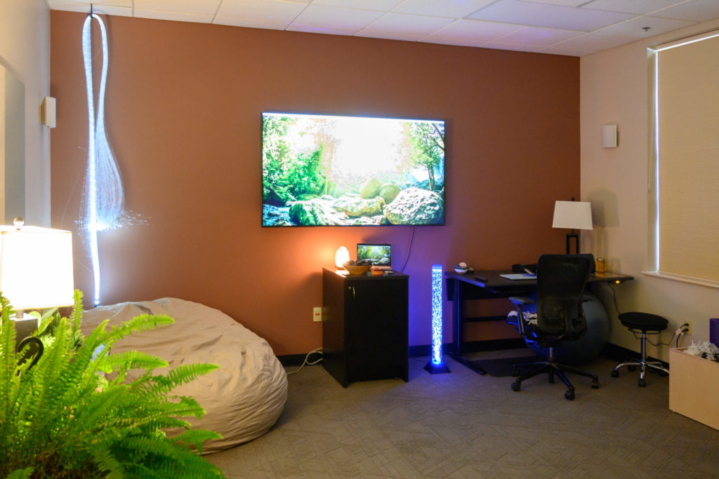 A screen and mood lighting in the Well-Being Room