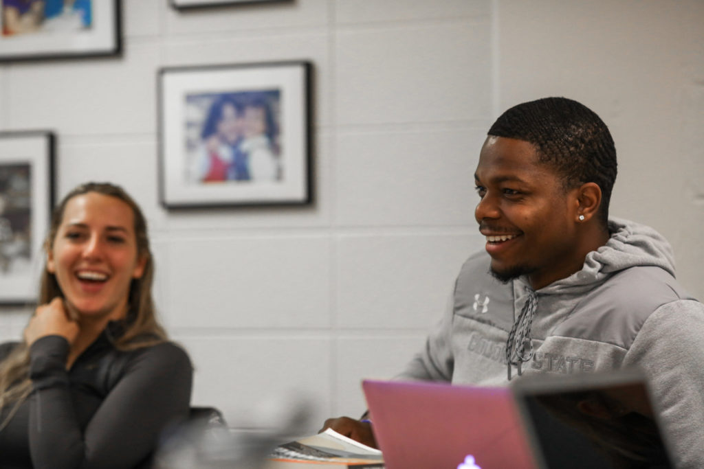 Two AET Students Smile During Class