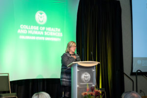 Dean Lise Youngblade speaking on stage at the scholarship dinner