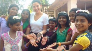Savanah Elliott in India smiling with children