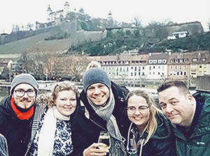 Five winter School participants in front of castle