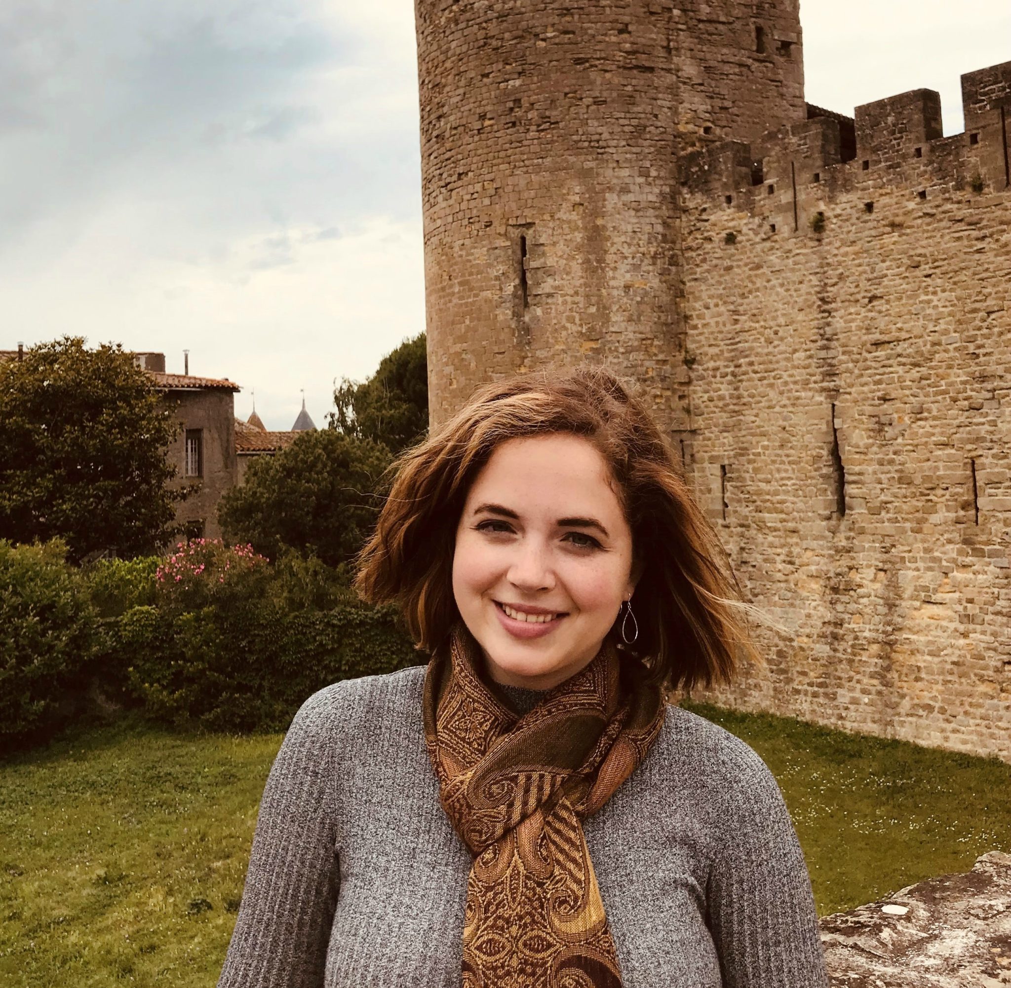 Isabelle Clement standing in front of a stone castle during her time in France