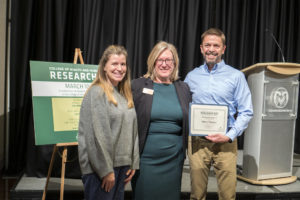 (Left to right) Kelly McKenna, Lise Youngblade, and James Folkestad pose at CHHS Research Day awards ceremony