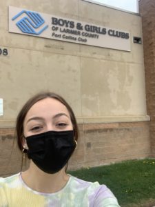 Alana Giles standing in front of the Boys and Girls Club.