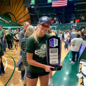 Sasha Colombo holding the Mountain West Conference Championship trophy for Volleyball in November 2019
