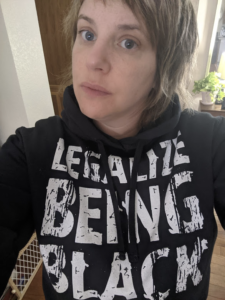 Lara Arndt with a sweatshirt that reads "Legalize being black"
