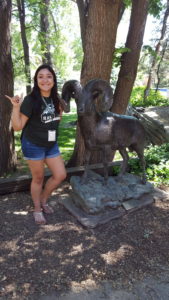 Tatianna Medina poses with a ram statue at CSU.