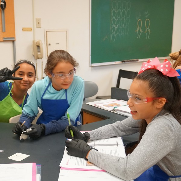 Girls doing an experiment with textiles in a lab