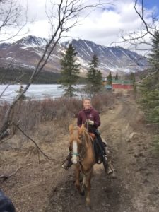 Shannon Perrins on a horse with a mountain in the background