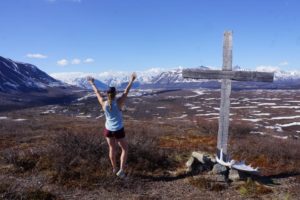 Shannon Perrins on top of a mountain with a cross