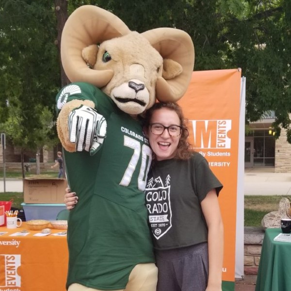 Cam the Ram poses with a student
