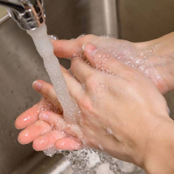 Close-up picture of hands being washed