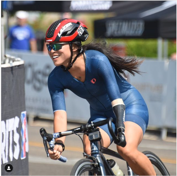 Josie Fouts smiling on a bike during a cycling race