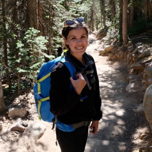 kalena Giessler smiling on a hiking trail