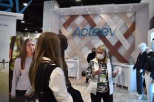 Students learning about textile technology from the Acteev booth