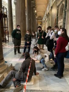 Study abroad students observing column-cleaning at the Pisa cathedral in Italy
