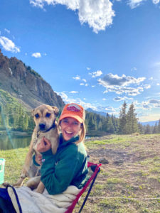 Hayley with her dog in a mountain landscape