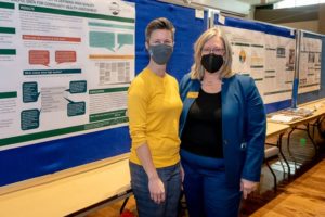 Molly Gutilla and Lise Youngblade in front of a research poster