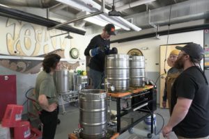 Students work with brewing equipment