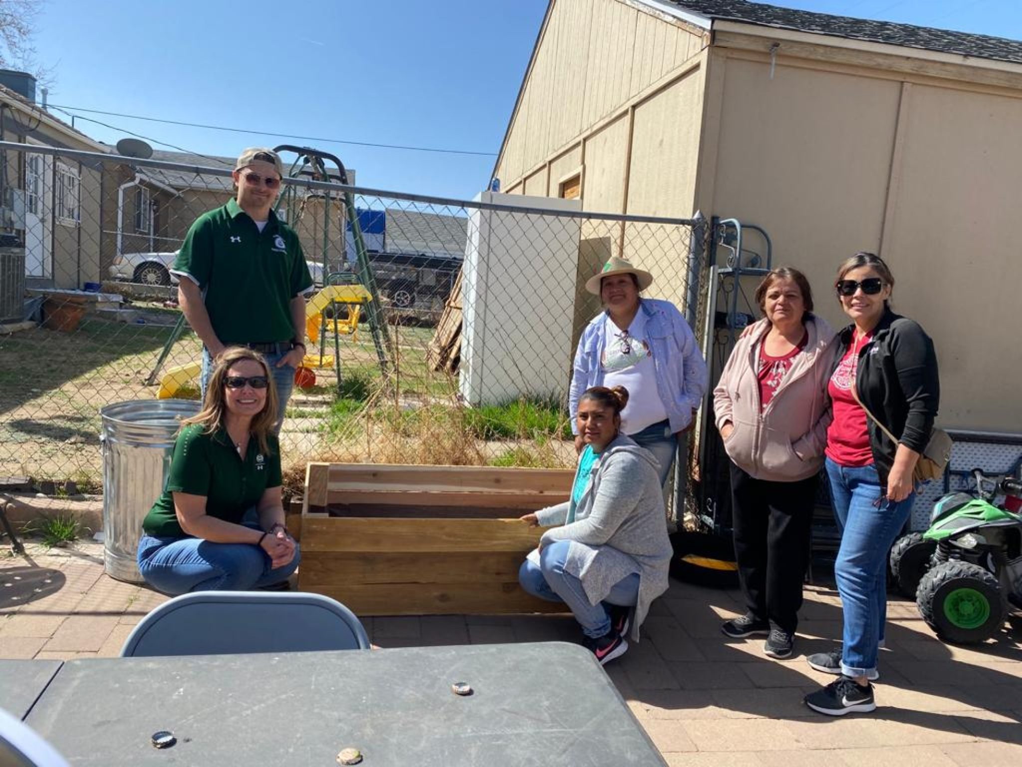Recipient of garden box with CM Cares members and community members