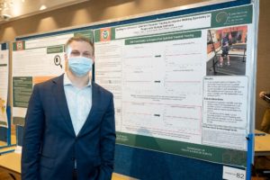Hagen next to his poster at the 2022 CHHS Research Day
