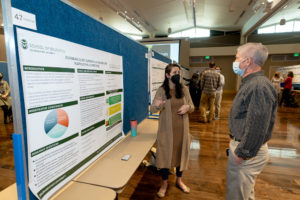 Jessica Gonzalez-Voller explains her poster at the CHHS Research Day event