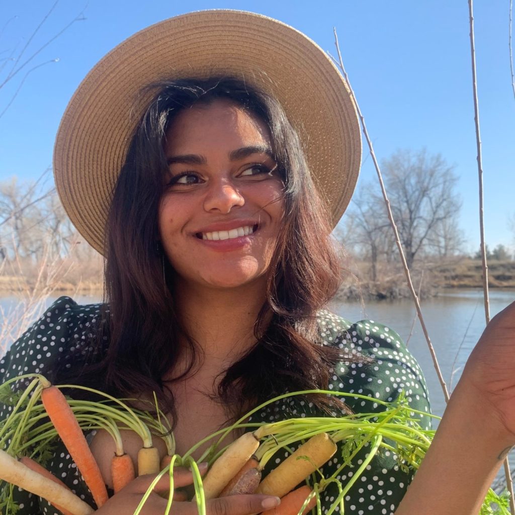 Allegra Vazquez holding fresh cut carrots