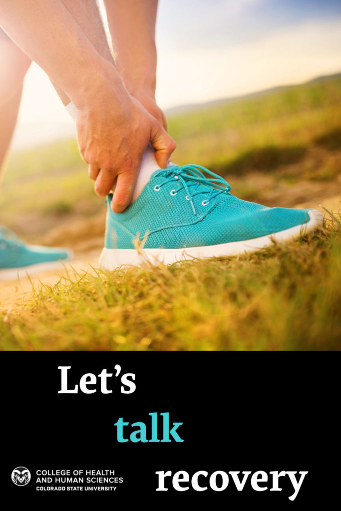Let's talk recovery - person in running shoe holds ankle