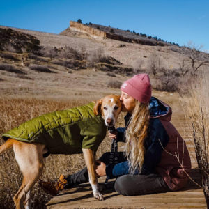Bella Olsson kissing her dog on the head at horsetooth
