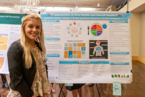 Lexi Walker with her poster "Intersection of Oral Health and Overall Health"