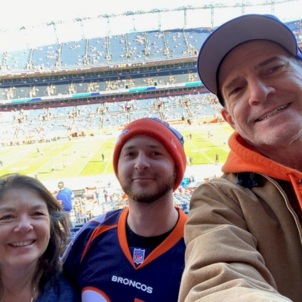 Matt Scherff with his parents at a Denver Broncos game