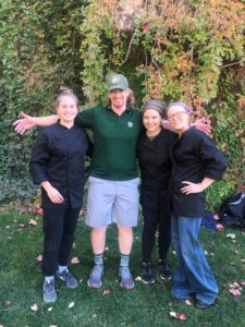 Instructor with three staff members of Gifford Catering outside of Gifford Building