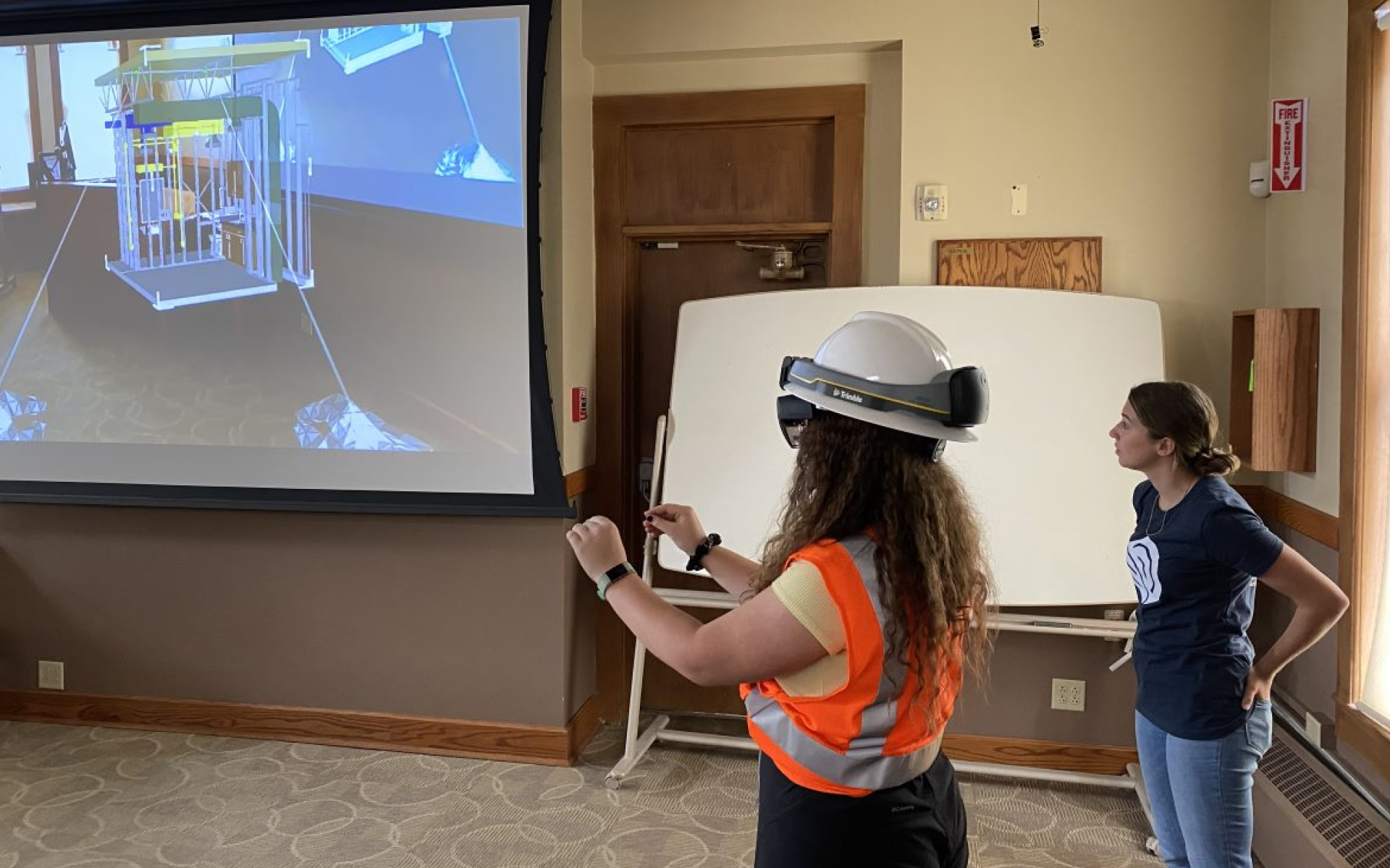 Virtual reality headset on girl with instructor to right side