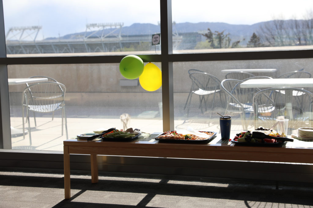 Food and set up for Dr. Barrett's celebration with stadium in background