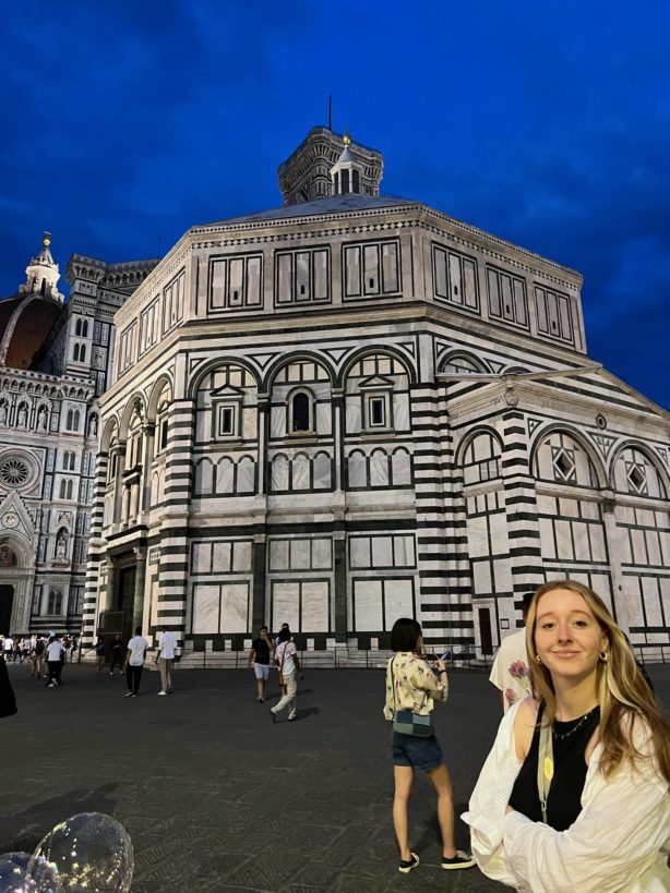 Photographed during the evening, interior architecture and design student Melissa Minervini stands in front of a historic building in Italy during her time abroad.