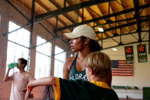 Bagley listens to and coaches one of the campers at the Glenn Morris Field House