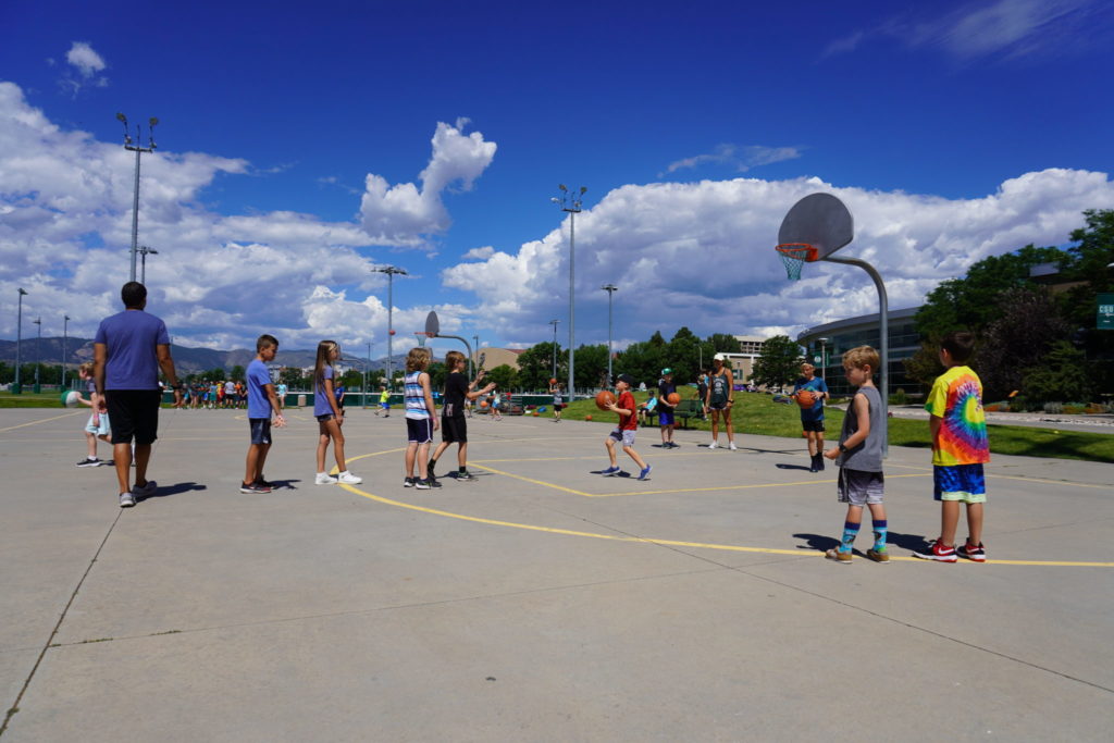 Campers line up for a game of knock out on the basketball courts