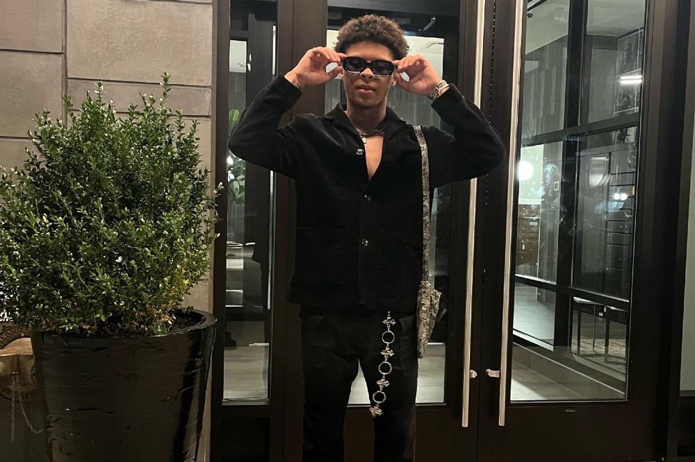 Cam Thomas wearing black clothes and sunglasses